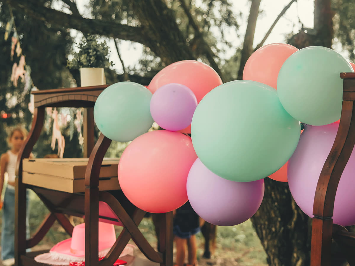 A pastel balloon arch in pink, purple and mint at a pony party